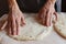 Household. A woman`s hands form the dough for baking. Family celebration