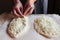 Household. Women`s hands form dough sprinkled with cheese for making khachapuri. Family celebration