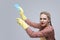 Household Working Caucasian Female Holding Blue Cleaning Sponge While Working In Yellow Rubber Gloves