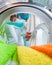 Householder woman using conditioner for washing machine