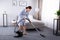 Housekeeper Cleaning Carpet With Vacuum Cleaner