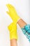Housekeeper wear yellow rubber gloves