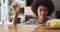 Housekeeping, face and woman cleaning the table with a cloth and detergent for dirt, dust or bacteria in her home