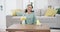 Housekeeping, headphones and woman cleaning the table with detergent, cloth and gloves at home. Female maid, cleaner or
