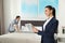 Housekeeping manager with tablet checking maid work in hotel room