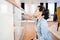 Housekeeping works - portrait of woman cleaning around the house. Woman using detergent and cloth for glass window cleaning