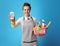 Housemaid with basket with detergents showing cell phone