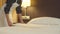 Housemaid make a bed and spread a blanket in hotel room