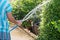 Housemaid spray water to garden