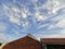 Housemate roof with blue sky and clouds background