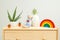 Houseplant and kids toys on wooden shelf. Plant home decoration. Life style