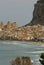 Houses along the shoreline and cathedral in background, Cefalu,