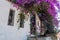 Houses and balconies of old town of Marmaris. Beautiful balcony with door, narrow windows, wrought iron fence surrounded by purple