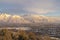 Houses beneath scenic Mount Timpanogos with cloudy blue sky overhead in winter