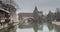 Houses and a bridge reflected in a river in the old town of Nuremberg seen from Henkersteg covered bridge across Pegnitz river