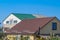 Houses with corrugated metal . Brown and green roof. Modern materials for roofing