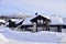 Houses covered in Snow with mountains behind. Hovden, Norway, Feb 2023.