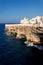 Houses on dramatic cliffs over Adriatic sea in Polignano a Mare, Italy, sunny day