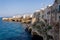 Houses on dramatic cliffs over Adriatic sea in Polignano a Mare, Italy, sunny day