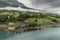 Houses on the hills surrounding Nordfjord Olden Norway.