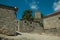 Houses made of stone with alley on slope and tower