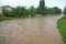 Houses near the shore of the raging river during the flood