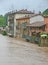 Houses near the shore of the raging river during the flood