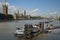 Houses of Parliament, local pier for boats, Big Ben, and Thames River.