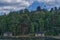 houses on a shore line the water and some trees and grass