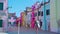 Houses stand on Burano street with clothes on clothesline