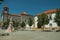 Houses and steeple in baroque style on square with statue