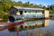 Houses on stilts rise above the polluted water in Islandia Peru