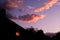 Houses on a suburban street silhouetted in evening sky