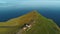 Houses on top of sea cape. Shot. Remote life in house on promontory with view of sea horizon. Top view of house on top