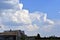 Houses and trees with blue clouds before a thunderstorm