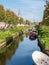 Houses with waterside gardens on Eegracht canal in IJlst, Friesland, Netherlands