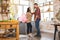 Housewarming couple. Young couple holding wine glasses in kitchen at home. Celebrating a holiday concept