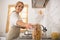 Housewife in apron looking busy in the kitchen