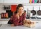 Housewife with basket with mushrooms in kitchen