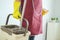The housewife is carrying cleaning equipment, wear rubber gloves lifting mop water bucket. Cleaning concept