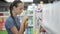 Housewife choosing body care products in supermarket.