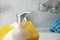 Housewife cleaning bathroom tap and shower Tap. Maid in yellow protective gloves washing dirty bath tap. Hands of woman washing or