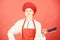 Housewife with cooking knife. professional chef in kitchen. Cuisine. butcher cut meat. woman in cook hat and apron