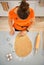 Housewife cutting out Halloween biscuits in kitchen. Upper view