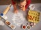 Housewife drawing christmas tree on kitchen table with flour