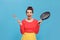 Housewife with frying pan and spatula on light blue background