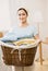 Housewife holding basket of laundry