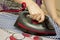 Housewife ironing a casual clothes on the ironing board closeup