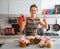 Housewife among jars with homemade fruits jam