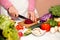 Housewife with a knife cutting beetroot, vegetable cutting in th